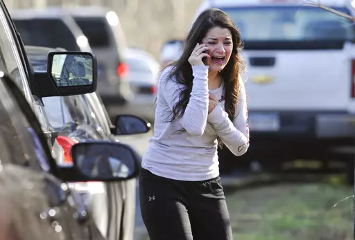 Carlee Soto uses a phone to get information about her sister, Victoria Soto, a teacher at the Sandy Hook elementary school in Newtown, Conn., after a gunman killed over two dozen people, including 20 children, on Dec. 14, 2012. An FBI agent struggled to control his emotions Tuesday, Sept. 13, 2022, as he described on the witness stand seeing bodies inside Sandy Hook elementary school — a scene that the conspiracy theorist Alex Jones later claimed was staged by actors. (AP Photo/Jessica Hill, F