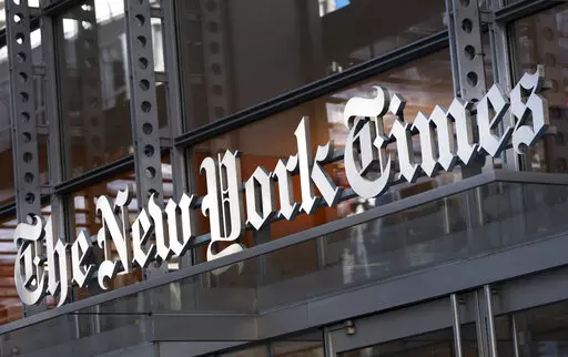 FILE - A sign for The New York Times hangs above the entrance to its building May 6, 2021, in New York. A New York judge has upheld an order preventing the Times from publishing documents between conservative group Project Veritas and its lawyer and ruled that the newspaper must immediately relinquish confidential legal memos it obtained. The decision Thursday, Dec. 23, by State Supreme Court Justice Charles D. Wood in Westchester County, released Friday, comes in a defamation lawsuit Project Ve