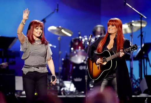 Naomi Judd, left, and Wynonna Judd, of The Judds, perform at the "Girls' Night Out: Superstar Women of Country," in Las Vegas, April 4, 2011. Fans will have a chance to say goodbye to Naomi Judd, the late matriarch of the Grammy-winning country duo The Judds, on a tour starting Friday. Wynonna Judd will helm the 11-city tour. (AP Photo/Julie Jacobson, File)