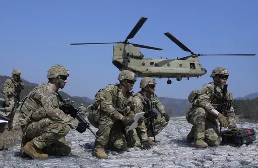 U.S. Army soldiers wait to board their CH-47 Chinook helicopter during a joint military drill between South Korea and the United States at Rodriguez Live Fire Complex in Pocheon, South Korea, Sunday, March 19, 2023. North Korea launched a short-range ballistic missile toward the sea on Sunday, its neighbors said, ramping up testing activities in response to U.S.-South Korean military drills that it views as an invasion rehearsal. (AP Photo/Ahn Young-joon)