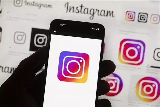 The Instagram logo is seen on a cell phone in Boston, USA, Oct. 14, 2022. Users of Meta's Facebook, Instagram, Threads and Messenger platforms are experiencing login issues in what appears to be a widespread outage. (AP Photo/Michael Dwyer, File)