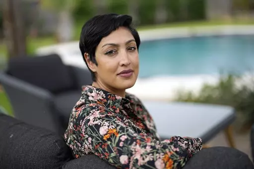 Rumman Chowdhury, co-founder of Humane Intelligence, a nonprofit developing accountable AI systems, poses for a photograph at her home Monday, May 8, 2023, in Katy, Texas. ChatGPT maker OpenAI, and other major AI providers such as Google and Microsoft, are coordinating with the Biden administration to let thousands of hackers take a shot at testing the limits of their technology. Chowdhury is the lead coordinator of the mass hacking event planned for this summer's DEF CON hacker convention in La