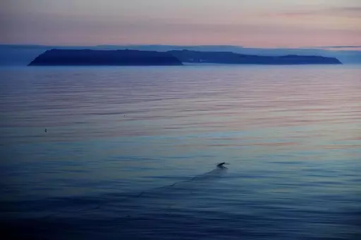 The American island of Little Diomede, Alaska, left, and on the right, the Russian island of Big Diomede, are seen from the Finnish icebreaker MSV Nordica in the Bering Strait, on July 14, 2017. The Alaska Air National Guard on April 3, 2023, traveled nearly 660 miles to rescue a pregnant woman on a small island two miles from Russia who had severe abdominal pains, a reflection of the challenges patients face in the nation's largest state where the most remote areas have no roads and hospitals c