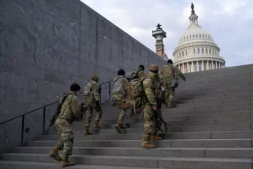 National Guard members take a staircase toward the U.S. Capitol building before a rehearsal for President-elect Joe Biden's Presidential Inauguration in Washington, Jan. 18, 2021. Soldiers are leaving the Army National Guard at a faster rate than they are enlisting, fueling concerns that in the coming years units around the country may not meet military requirements for overseas and other deployments. Officials say the number of soldiers retiring or leaving the Guard each month in the past year 