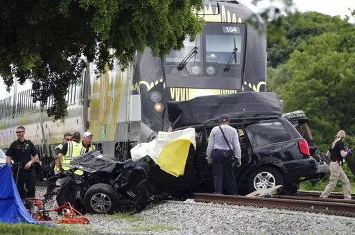 In this Aug 25, 2019 file photo, Broward Sheriff's Deputies and Pompano Beach Fire Rescue work the scene of a fatal accident on North Dixie Highway in Pompano Beach, Fla. South Florida's higher-speed railroad, other train lines and local officials  met with federal safety officials Wednesday, Feb. 23, 2022 to begin working out plans that they hope will decrease the number of fatal strikes between locomotives, cars and pedestrians. (Joe Cavaretta/South Florida Sun-Sentinel via AP)