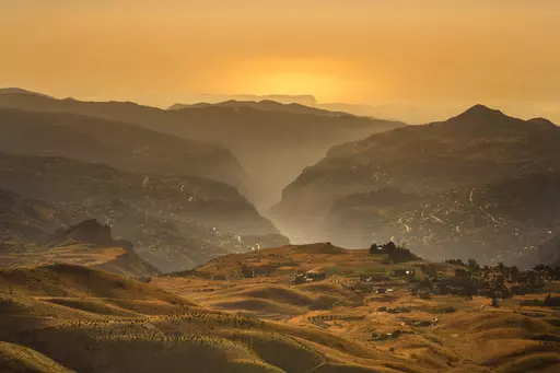 Young cedar trees that have been planted in a forestation initiative 2,400 meters above sea level, bottom left, are scattered in open land overlooking the Kadisha Valley, covered by fog, considered a holy site to Lebanon's Maronite Christians, in the northeast mountain town of Bcharre, Lebanon, Saturday, July 22, 2023. For Lebanon's Christians, the cedars are sacred, these tough evergreen trees that survive the mountain's harsh snowy winters. They point out with pride that Lebanon's cedars are m