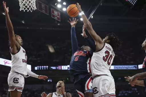 Mississippi guard Jaylen Murray (5) scores and is fouled by South Carolina forward Collin Murray-Boyles (30) during the first half of an NCAA college basketball game Tuesday, Feb. 6, 2024, in Columbia, S.C. (AP Photo/Artie Walker Jr.)