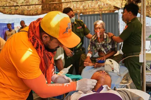 A Bhutan medical volunteer attends to a patient at their make-shift tent after last week's earthquake in Naypyitaw, Myanmar, Friday, April 4, 2025. (AP Photo)