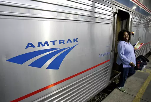A passenger disembarks from Amtrak's Sunset Limited at its final stop in New Orleans, Nov. 2, 2008. The Biden administration announced Monday, Sept. 25, 2023, that it has awarded more than $1.4 billion to projects that improve railway safety and boost capacity, with much of the money coming from the 2021 infrastructure law. (AP Photo/Pat Semansky, File)