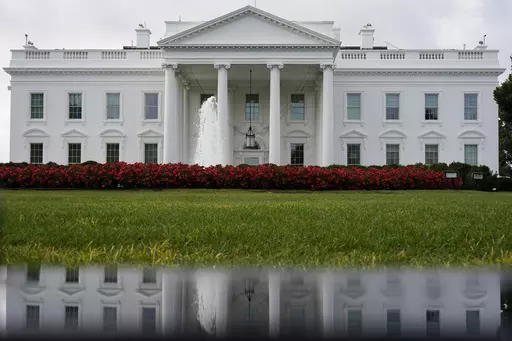 The White House is seen reflected in a puddle, Sept. 3, 2022, in Washington. The U.S. Senate confirmed Todd Gee on Friday, Sept. 29, 2023, to be the U.S. Attorney for the Southern District of Mississippi, putting him in charge of prosecuting the largest public corruption scandal in state history. (AP Photo/Carolyn Kaster, File)