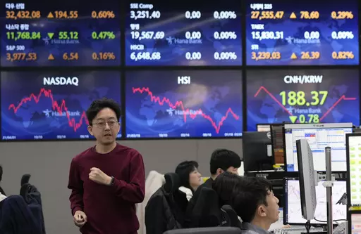 A currency trader passes by the screens showing the foreign exchange rates at the foreign exchange dealing room of the KEB Hana Bank headquarters in Seoul, South Korea, Tuesday, March 28, 2023. Asian shares were mostly higher on Tuesday as investors got some relief from worries over troubled U.S. banks with a planned takeover of failed Silicon Valley Bank.(AP Photo/Ahn Young-joon)