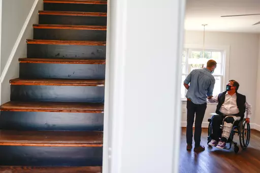 BoundaryLess Living founder and CEO William Sweeney, chats with an attendee on Nov. 17, 2021 at a BoundaryLess Living adaptive living home in Richmond, Va. Roughly 1.8 million businesses in the U.S. are owned by someone with a disability, according to the American Community Survey conducted by the U.S. Census Bureau. And while the path to entrepreneurship is rarely easy, business owners with disabilities often need to overcome additional challenges, like societal misconceptions, barriers to fina