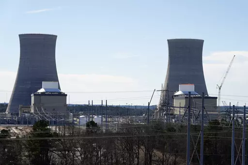 Units 3, left, and 4 and their cooling towers stand at Georgia Power Co.'s Plant Vogtle nuclear power plant, Jan. 20, 2023, in Waynesboro, Ga. Residential customers of Georgia's largest electrical utility could see their bills rise another $9 a month to pay for a new nuclear power plant under a deal announced Wednesday, Aug. 30. Georgia Power Co. said customers would pay $7.56 billion more for Plant Vogtle construction costs under the agreement with utility regulatory staff. (AP Photo/John Bazem