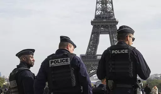 Police officers patrol the Trocadero plaza near the Eiffel Tower in Paris, Tuesday, Oct. 17, 2023. Police have arrested a man climbing on the Eiffel Tower. The drama temporarily stranded a crowd at the top. Among those trapped was a Washington, D.C., couple who decided during the wait to get married and an Associated Press reporter who got their story. Amir Khan had been planning to propose to Kate Warren later Thursday in a Paris garden away from the crowds, with a romantic dinner on the River 