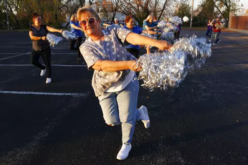 Pam Junion, 65, and other members of the Milwaukee Dancing Grannies practice in a parking lot in Milwaukee on Wednesday, Nov. 2, 2022. Junion is one of a few women who answered a call for new members as the group attempted to rebuild in the face of tragedy. Three Dancing Grannies and one group member’s husband were among those killed at a Christmas parade in Waukesha, Wisconsin, when the driver of an SUV struck them on the parade route. Dozens more, including some Grannies, were injured. (AP P