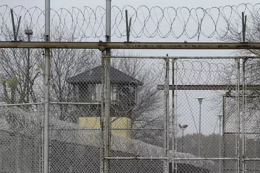 Security fences surround the Illinois Department of Corrections' Logan Correctional Center, Nov. 18, 2016, in Lincoln, Ill. Illinois Gov. J.B. Pritzker's administration has retained a contentious choice for providing medical care to prison inmates, awarding Wexford Health Sources a 10-year, $4.16 billion contract despite high vacancy rates, complaints of substandard care and lawmakers' agitation to find a replacement. (AP Photo/Seth Perlman, File)