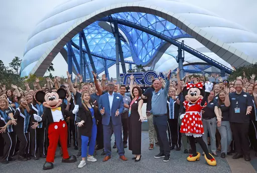 Mickey, Minnie and cast members join Walt Disney World executives in a ceremony marking the official opening of Tron Lightcycle / Run at the Magic Kingdom in Lake Buena Vista, Fla., on Monday, April 3, 2023. The roller coaster opens to guests on Tuesday. From left are Mickey Mouse; Ali Manion, Walt Disney World ambassador; Perry Crawley, Magic Kingdom operations general manager; Melissa Valiquette, vice president of Magic Kingdom; Jason Kirk, senior vice president of operations for Walt Disney W