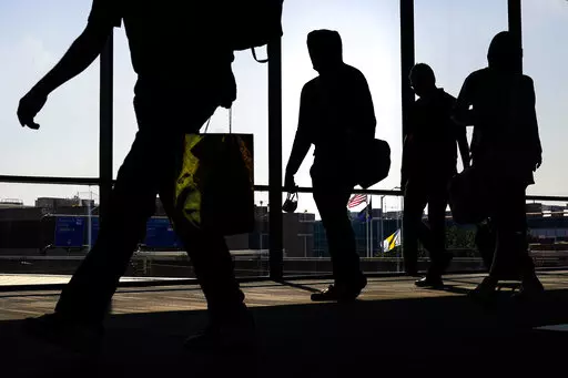 Arriving passengers move toward the baggage claim area at Philadelphia International Airport in Philadelphia on Friday, July 1, 2022. Travelers will probably pay more for airline tickets or a hotel room around the holidays than they did over last Thanksgiving or Christmas. (AP Photo/Matt Rourke, File)