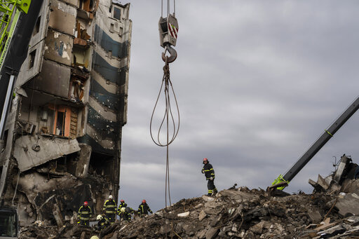 Firefighters work on a destroyed apartment building in the town of Borodyanka, Ukraine, on Saturday, April 9, 2022. Russian troops occupied the town of Borodyanka for weeks. Several apartment buildings were destroyed during fighting between the Russian troops and the Ukrainian forces in the town around 40 miles northwest of Kiev. (AP Photo/Petros Giannakouris)