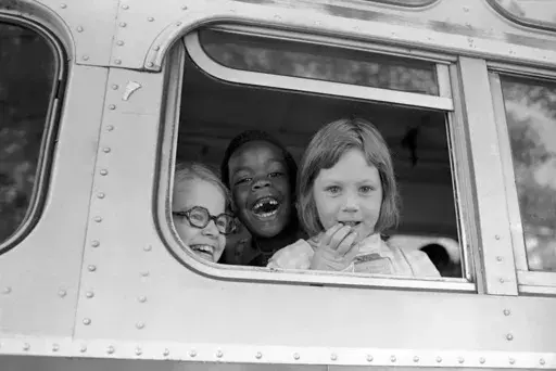 Children smile from window of a school bus in Springfield, Mass., as court-ordered busing brought Black children and white children together in elementary grades without incident, Sept. 16, 1974. Friday, May 17, 2024, marks 70 years since the U.S. Supreme Court ruled that separating children in schools by race was unconstitutional. On paper, Brown v. Board of Education still stands. In reality, school integration is all but gone, the victim of a gradual series of court cases that slowly eroded i