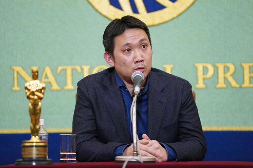 Film director Ryusuke Hamaguchi, with actor Hidetoshi Nishijima and producer Akihisa Yamamoto, unseen, speaks during a news conference on their award winning film "Drive My Car" in Tokyo, Tuesday, April 5, 2022. Japan's "Drive My Car" has won an Oscar for best international feature. (AP Photo/Hiro Komae)