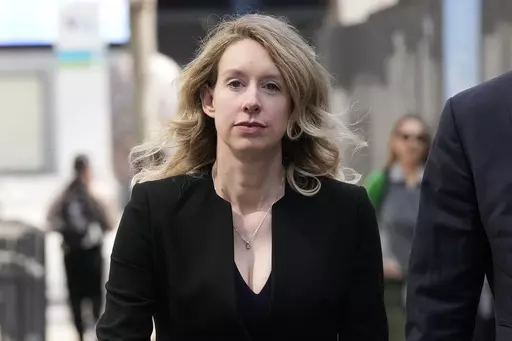 Former Theranos CEO Elizabeth Holmes leaves federal court in San Jose, Calif., March 17, 2023. Holmes has asked a federal judge, Wednesday, May 17, 2023, to allow her to remain free through the Memorial Day weekend before surrendering to authorities on May 30, to begin her more than 11-year prison sentence for defrauding investors in a blood-testing scam. (AP Photo/Jeff Chiu, File)