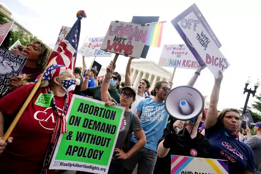 People protest about abortion, Friday, June 24, 2022, outside the Supreme Court in Washington. The Supreme Court has ended constitutional protections for abortion that had been in place nearly 50 years — a decision by its conservative majority to overturn the court's landmark abortion cases. (AP Photo/Steve Helber)