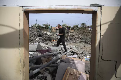 Palestinians inspect the ruins of a residential building for the Abu Muammar family after an Israeli airstrike in Rafah, southern Gaza Strip, Friday, March 29, 2024. (AP Photo/Hatem Ali)