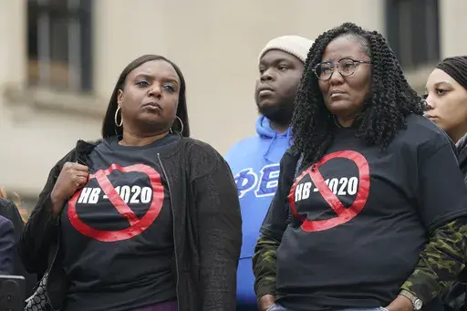 People voicing their opposition to Mississippi House Bill 1020 wear protest t-shirts as they gathered on the steps of the Mississippi Capitol in Jackson, Jan. 31, 2023. (AP Photo/Rogelio V. Solis, File)