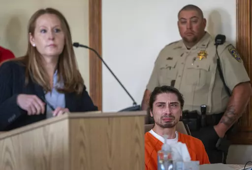 Ryan Martinez, seated, cries during his preliminary and detention hearing in Tierra Amarilla, N.M., Friday, Oct. 13, 2023, as his attorney Nicole Moss, describes the events that led to him allegedly shooting Jacob Johns during a rally outside the Rio Arriba County Complex in Espanola. An appeals court Monday, Nov. 20, has upheld a judge’s decision to deny bail to Martinez who is charged with attempted murder in the September shooting of a Native American activist during confrontations about ca