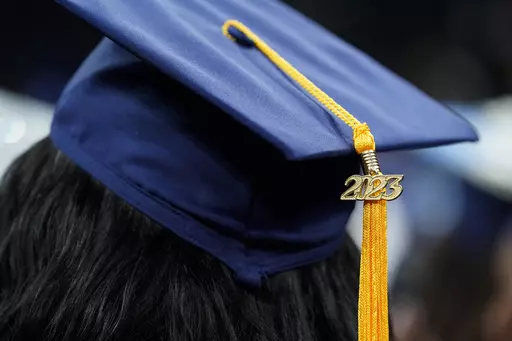 A tassel with 2023 on it rests on a graduation cap as students walk in a procession for Howard University's commencement in Washington, Saturday, May 13, 2023. The Supreme Court is getting ready to decide some of its biggest cases of the term, including the fate of President Joe Biden’s plan to wipe away or reduce student loans held by millions of Americans. (AP Photo/Alex Brandon, File)