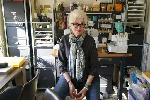 Mary Beth Orr poses for a photo in her home, Tuesday, Aug. 23, 2022 in Burien, Wash., south of Seattle. Orr used to have five or six drinks every evening and more on weekends before she enrolled in a study in 2018 to see if the compound in psychedelic mushrooms could help heavy drinkers cut back or quit entirely. She stopped drinking entirely for two years, and now has an occasional glass of wine, and credits psilocybin for her progress. (AP Photo/Ted S. Warren)