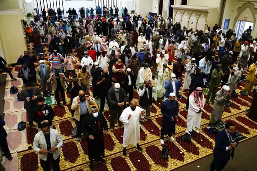 Worshippers perform an Eid al-Fitr prayer at the Masjidullah Mosque in Philadelphia, Thursday, May 13, 2021. This year, in a rare convergence, Judaism’s Passover, Christianity’s Easter and Islam’s holy month of Ramadan are interlapping in April with holy days for Buddhists, Baha’is, Sikhs, Jains and Hindus, offering different faith groups a chance to share meals and rituals in a range of interfaith events. (AP Photo/Matt Rourke, File)