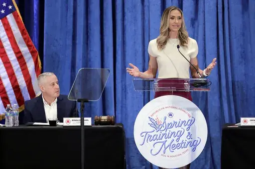 Lara Trump, the newly elected Republican National Committee Co-Chair, right, gives an address as newly elected Chairman Michael Whatley, left, listens during the general session of the RNC Spring Meeting Friday, March 8, 2024, in Houston. (AP Photo/Michael Wyke, File)