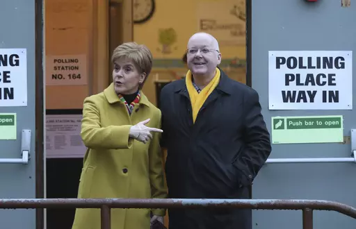 Scottish First Minister Nicola Sturgeon poses for the media with husband Peter Murrell, outside polling station in Glasgow, Scotland, on Dec. 12, 2019. Scotland police say the treasurer of the Scottish National Party has been arrested in a party finance probe. Colin Beattie, a member of Scottish Parliament, was arrested Tuesday, April 18, 2023 in an investigation into how 600,000 pounds ($745,000) designated for a Scottish independence campaign was spent. The arrest comes two weeks after the par