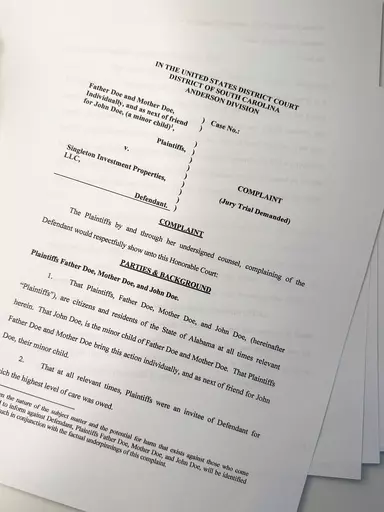 A lawsuit is seen on Thursday, July 27, 2023, in Atlanta. The parents of a teenager with special needs say he was repeatedly sexually assaulted and raped by an employee at the small private boarding school in South Carolina. They have sued the school's parent company, which has denied the allegations. (AP Photo/Brynn Anderson)