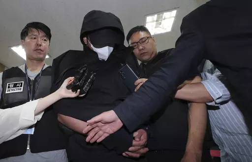 A man who opened an emergency exit door during a flight, arrives to attend an arrest warrant review at the Daegu District Court in Daegu, South Korea, Sunday, May 28, 2023. He told police that he felt suffocated and tried to get off the plane quickly as it approached landing, reports said Saturday. (Yun Kwan-shick/Yonhap via AP)