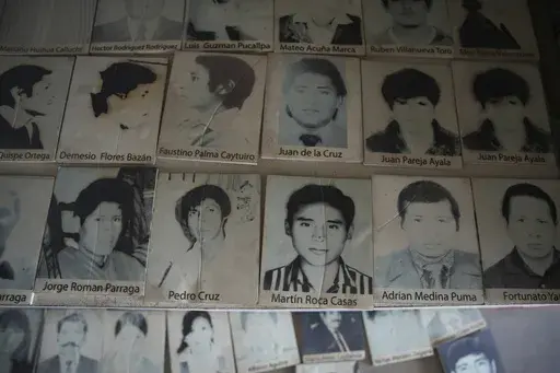 Photos of people who disappeared during Peru's internal armed conflict (1980-2000) lie on display at the House of Memory museum in Lima, Peru, Sunday, Oct. 20, 2024. (AP Photo/Guadalupe Pardo)