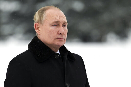 In this Jan. 27, 2022, photo, Russian President Vladimir Putin attends a wreath laying commemoration ceremony at the Piskaryovskoye Cemetery where most of the Leningrad Siege victims were buried during World War II, in St. Petersburg, Russia. The White House and U.S officials have threatened Russia with financial sanctions carrying “severe consequences” if Moscow invades Ukraine, but so far plenty of individuals have been prime targets for Western pain. Experts say it’s unlikely the U.S. a