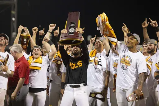 Tennessee coach Tony Vitello, center, hoists the championship trophy following his team's 6-5 victory against Texas A&M in Game 3 of the NCAA College World Series baseball finals in Omaha, Neb., June 24, 2024. (AP Photo/Rebecca S. Gratz, File)