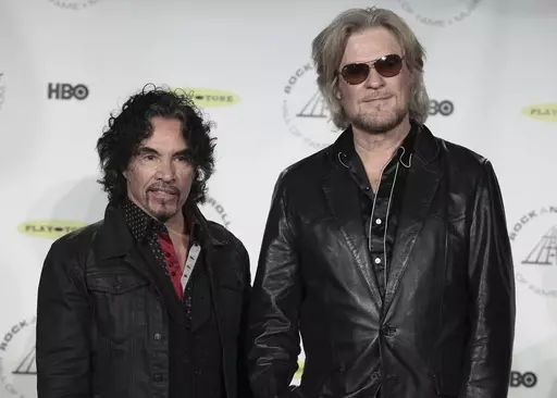 Hall of Fame Inductees, Hall & Oates, John Oates and Daryl Hall appear in the press room at the 2014 Rock and Roll Hall of Fame Induction Ceremony on April, 10, 2014, in New York. Hall has sued his longtime music partner John Oates, arguing that his plan to sell off his share of a joint venture would violate a business agreement the duo had. (Photo by Andy Kropa/Invision/AP, File)
