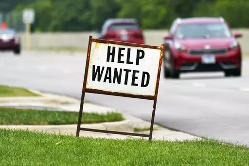 A help wanted sign is displayed at a gas station in Mount Prospect, Ill., Tuesday, July 27, 2021.  Fewer Americans applied for unemployment benefits last week as layoffs remain at historically low levels.  Jobless claims fell by 5,000 to 166,000 for the week ending April 2, 2022 the Labor Department reported Thursday.  (AP Photo/Nam Y. Huh)