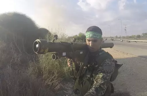 In this image from body camera video during the Oct. 7, 2023, surprise attack on Israel, a Hamas fighter holds a Russian-designed 9M32 Strela anti-aircraft missile. An Associated Press analysis of more than 150 videos and photos taken in the three months of combat since Hamas launched its Oct. 7 surprise attack on Israel shows the militant group has amassed a diverse patchwork arsenal of weapons from around the world – much of it smuggled past a 17-year blockade that was aimed at stopping just