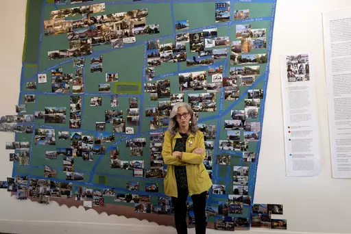 Writer and activist Judy Branfman stands by a map she created as part of a gallery installation at Beyond Baroque gallery, Friday, Nov. 3, 2023, in the Venice Beach area of Los Angeles. The gallery installation offers a unique art-meets-data look at the eviction crisis in the Venice Beach neighborhood. The exhibit titled "Where Has All The (affordable) Housing Gone?" gathers maps, photos, statistics, paintings, poems and the stories of people who have been evicted from their homes, including the
