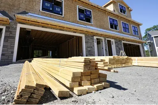 Lumber is piled at a housing construction site, Thursday, June 24, 2021, in Middleton, Mass. (AP Photo/Elise Amendola, File)