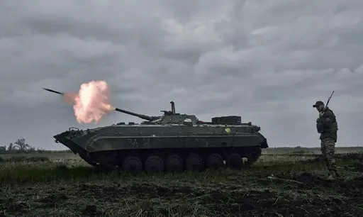 A Ukrainian APC fires towards Russian positions near Avdiivka, in the Donetsk region, Ukraine, Friday, April 28, 2023. A dayslong attempt by Russian forces to storm a strategically important city in eastern Ukraine appears to be running out of steam, Kyiv officials claimed Monday, Oct. 16, 2023 as the Kremlin’s war entered its 600th day. (AP Photo/Libkos, File)