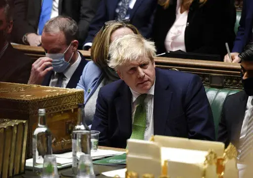 In this photo provided by UK Parliament, Britain's Prime Minister Boris Johnson attends Prime Minister's Questions in the House of Commons, in London, Jan. 19, 2022. Some Conservative lawmakers in Britain are talking about ousting Johnson, who has been tarnished by allegations that he and his staff held lockdown-breaching parties during the coronavirus pandemic. The party has a complex process for changing leaders that starts by lawmakers writing letters to demand a no-confidence vote. (Jessica 