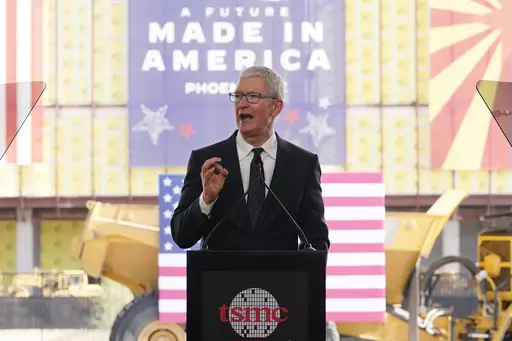 Apple CEO Tim Cook speaks at the Taiwan Semiconductor Manufacturing Company facility under construction in Phoenix, on Dec. 6, 2022. Multinational corporations are seeking to produce more items - especially semiconductors - in the United States. Apple will use chips made at the facility. (AP Photo/Ross D. Franklin, File)