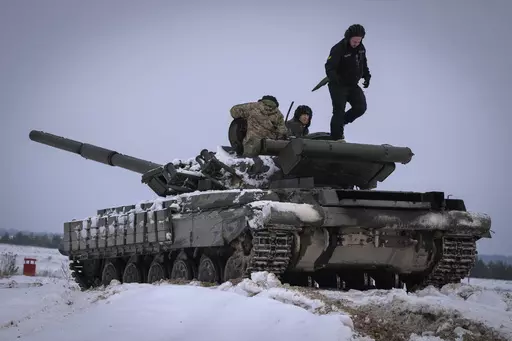 Ukrainian soldiers practice on a tank during military training, in Ukraine, Wednesday, Dec. 6, 2023. A gloomy mood hangs over Ukraine’s soldiers nearly two years after Russia invaded their country. Ukrainian soldiers remain fiercely determined to win, despite a disappointing counteroffensive this summer and signs of wavering financial support from allies. (AP Photo/Efrem Lukatsky, File)