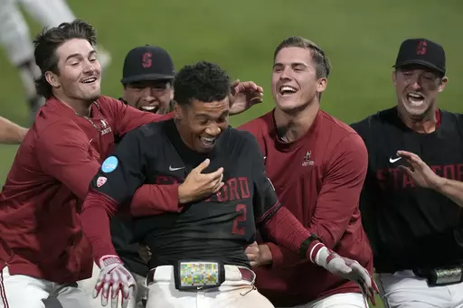 Stanford's Drew Bowser (2) celebrates with teammates after hitting a single to score the winning run against Texas in the ninth inning of an NCAA college baseball tournament super regional game in Stanford, Calif., Monday, June 12, 2023. Stanford won 7-6. (AP Photo/Tony Avelar)